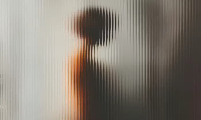 Silhouette seen through ribbed glass